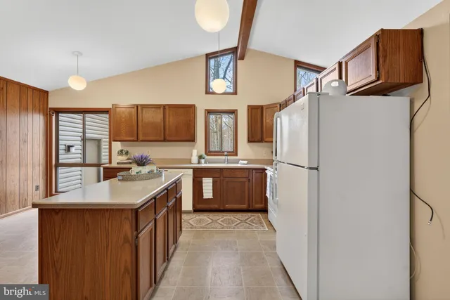 a kitchen with stainless steel appliances a refrigerator and a stove top oven