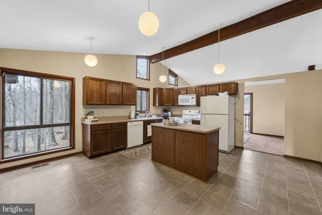 a kitchen with stainless steel appliances a refrigerator and a stove top oven