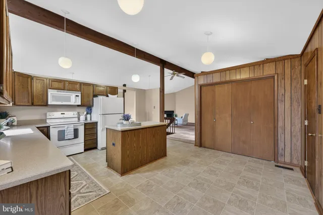 a kitchen with stainless steel appliances a sink stove and cabinets