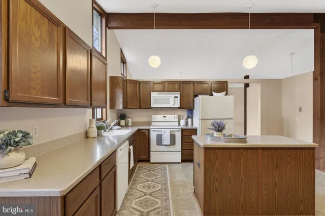 a kitchen with a sink a stove a refrigerator and cabinets