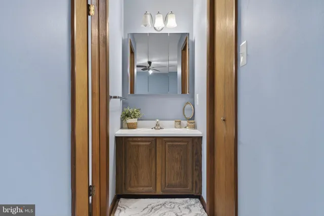 a bathroom with a sink vanity mirror and toilet