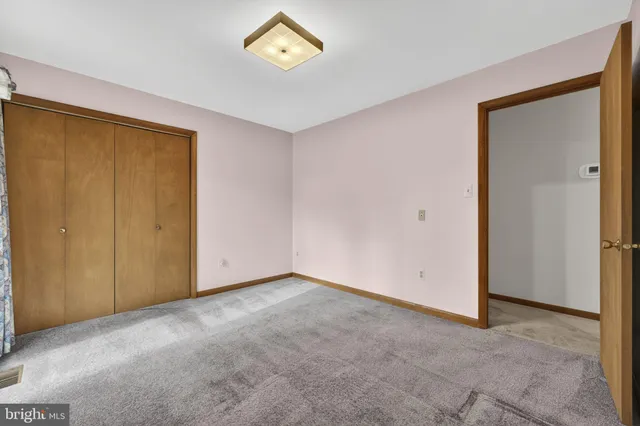 a hallway with a table and chairs