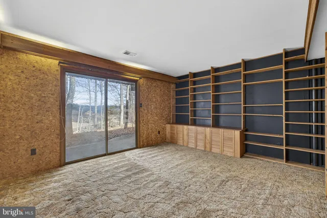 a front view of a house with large trees