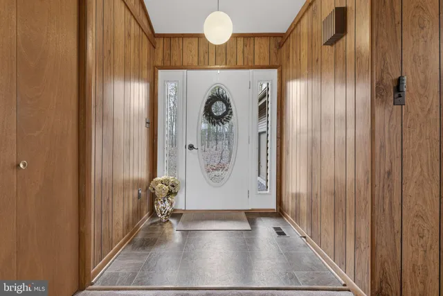 a view of an entryway with wooden floor