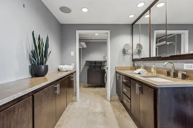 a kitchen with kitchen island a sink appliances and cabinets