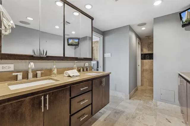 a bathroom with a sink double vanity and a mirror