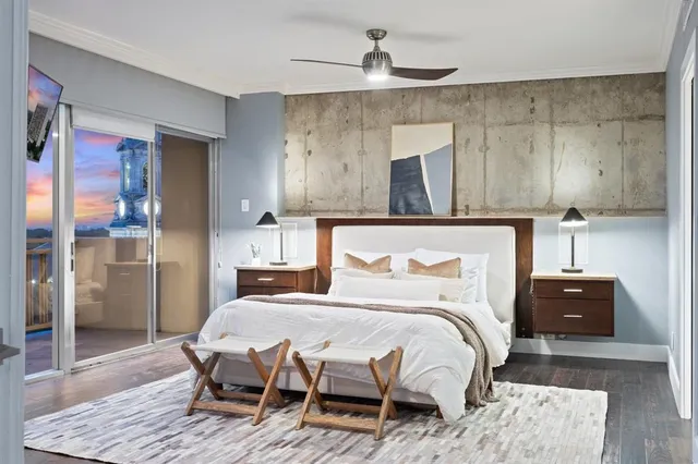 a bedroom with a bed and wooden floor