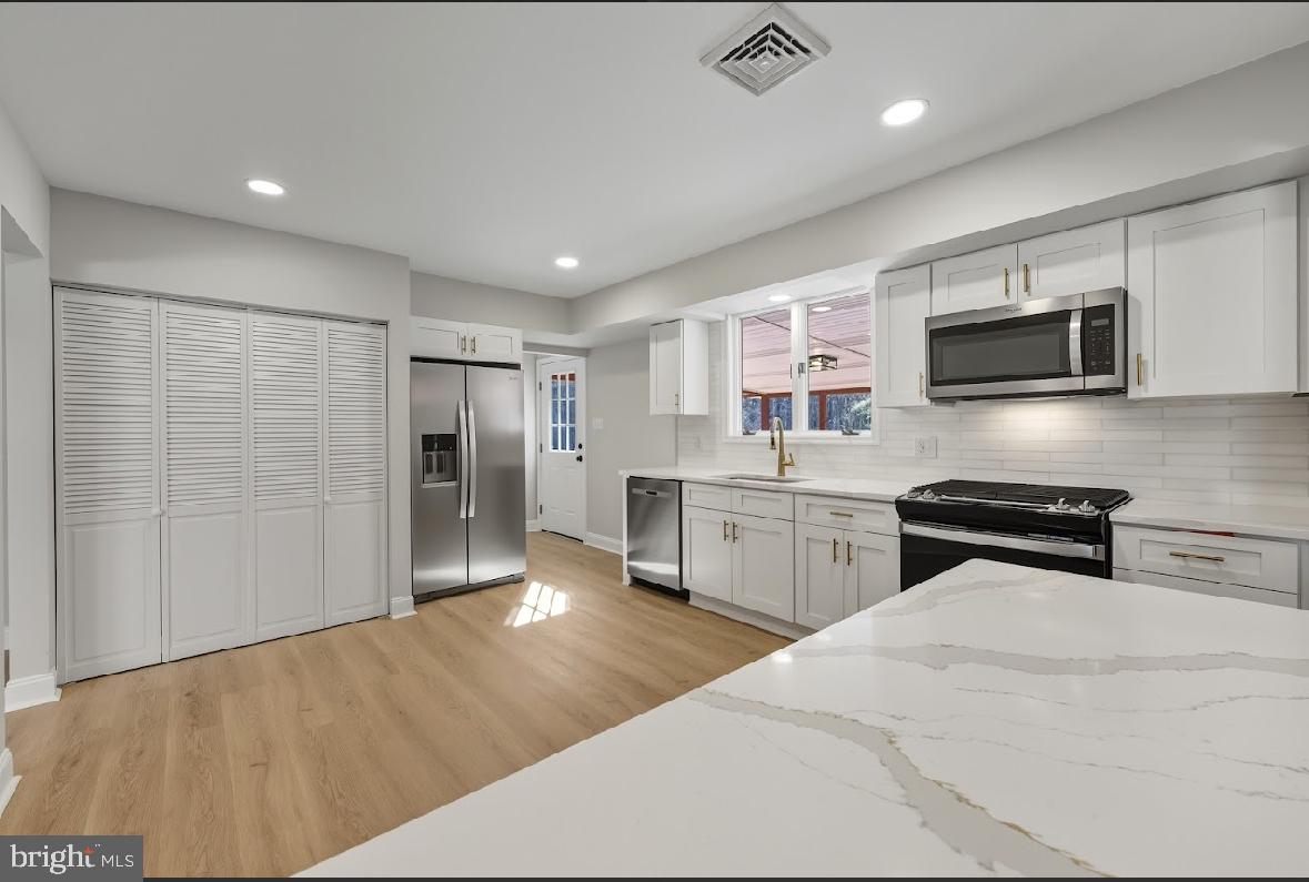 825 Mays Landing Road Hammonton, NJ 08037 - Photo 12 of 33 a kitchen with stainless steel appliances kitchen island granite countertop a stove a sink and a refrigerator