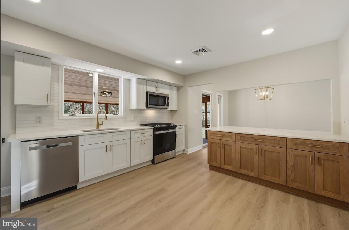 825 Mays Landing Road Hammonton, NJ 08037 - Photo 14 of 33 a large kitchen with granite countertop a stove top oven sink and cabinets