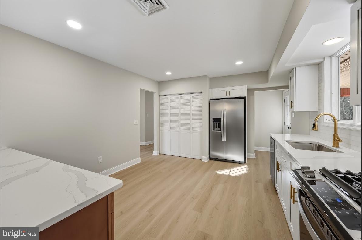 825 Mays Landing Road Hammonton, NJ 08037 - Photo 16 of 33 a view of a kitchen cabinets a sink and a stove