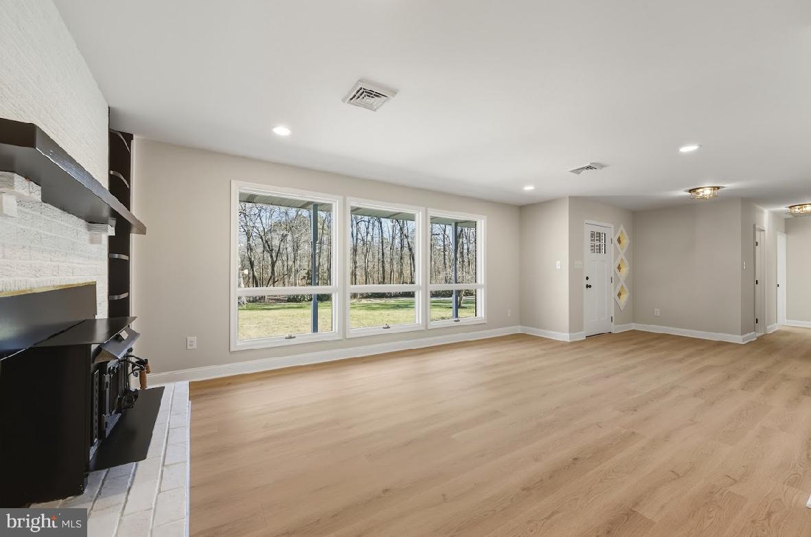 825 Mays Landing Road Hammonton, NJ 08037 - Photo 3 of 33 a view of an empty room with a fireplace and a large window
