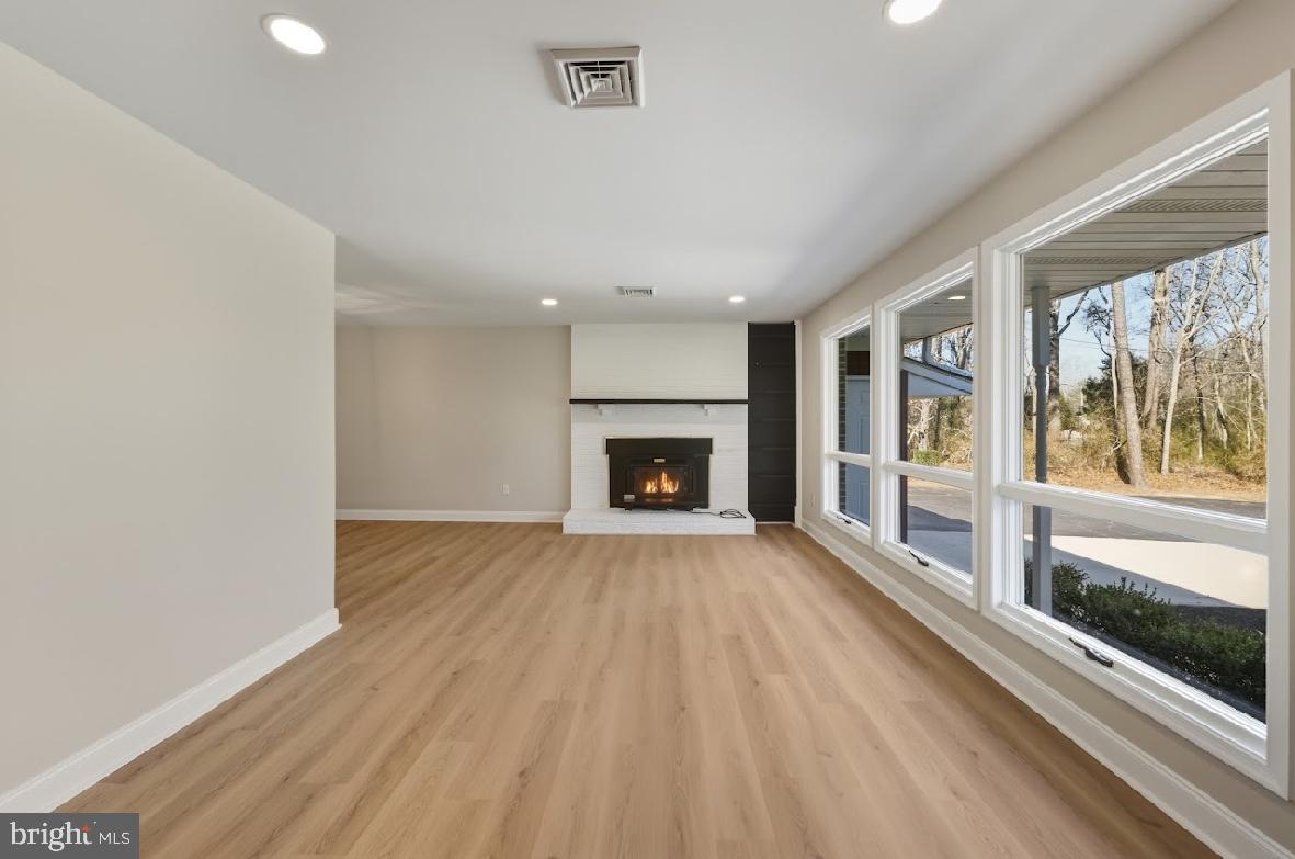 825 Mays Landing Road Hammonton, NJ 08037 - Photo 4 of 33 a view of an empty room with a fireplace and a window