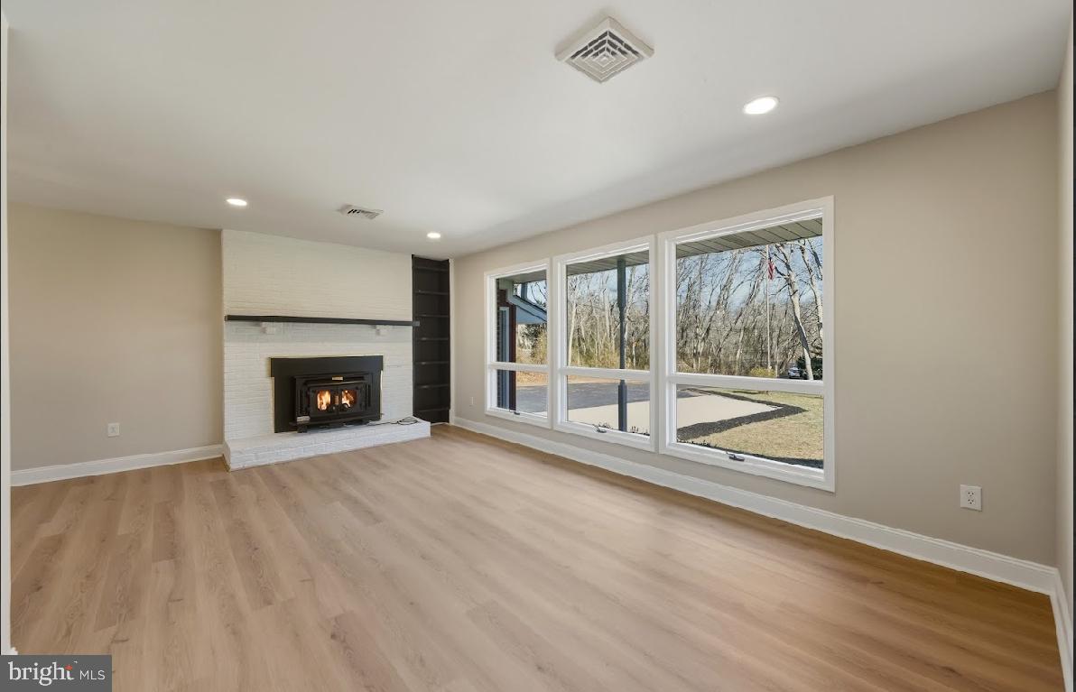 825 Mays Landing Road Hammonton, NJ 08037 - Photo 7 of 33 a view of an empty room with wooden floor and a fireplace