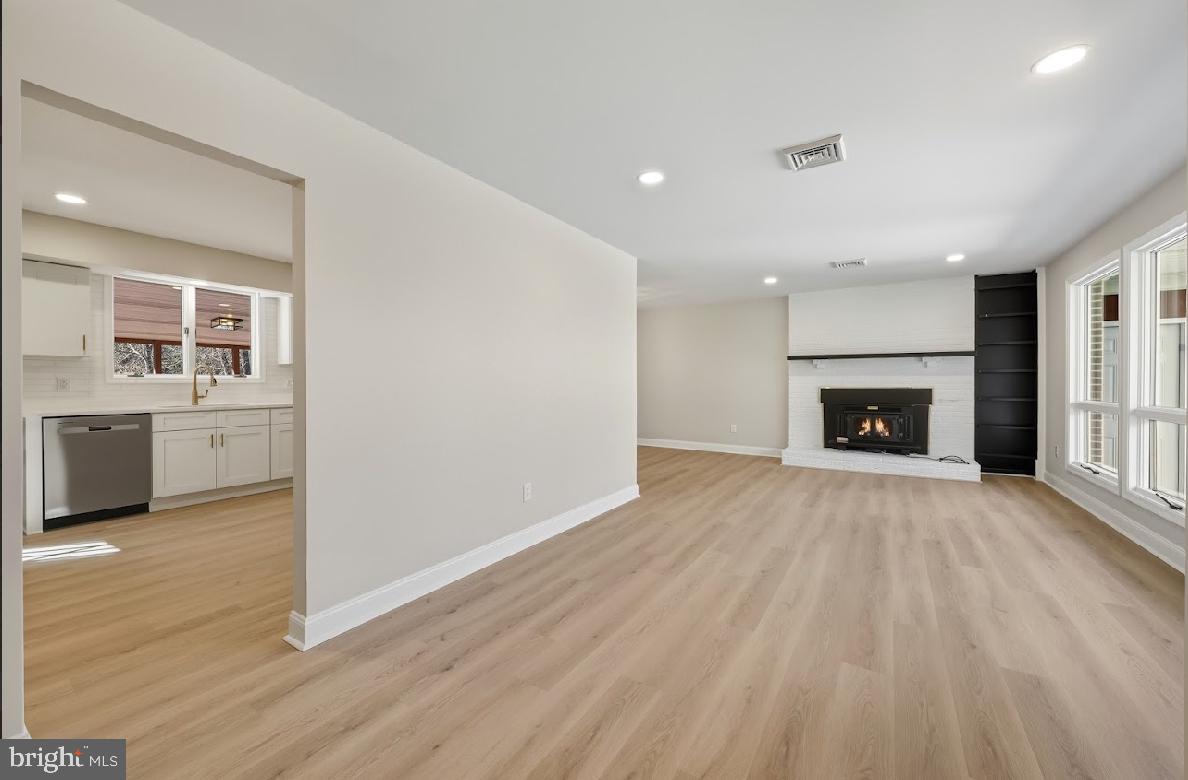 825 Mays Landing Road Hammonton, NJ 08037 - Photo 8 of 33 a view of a livingroom with a fireplace a ceiling fan and wooden floor