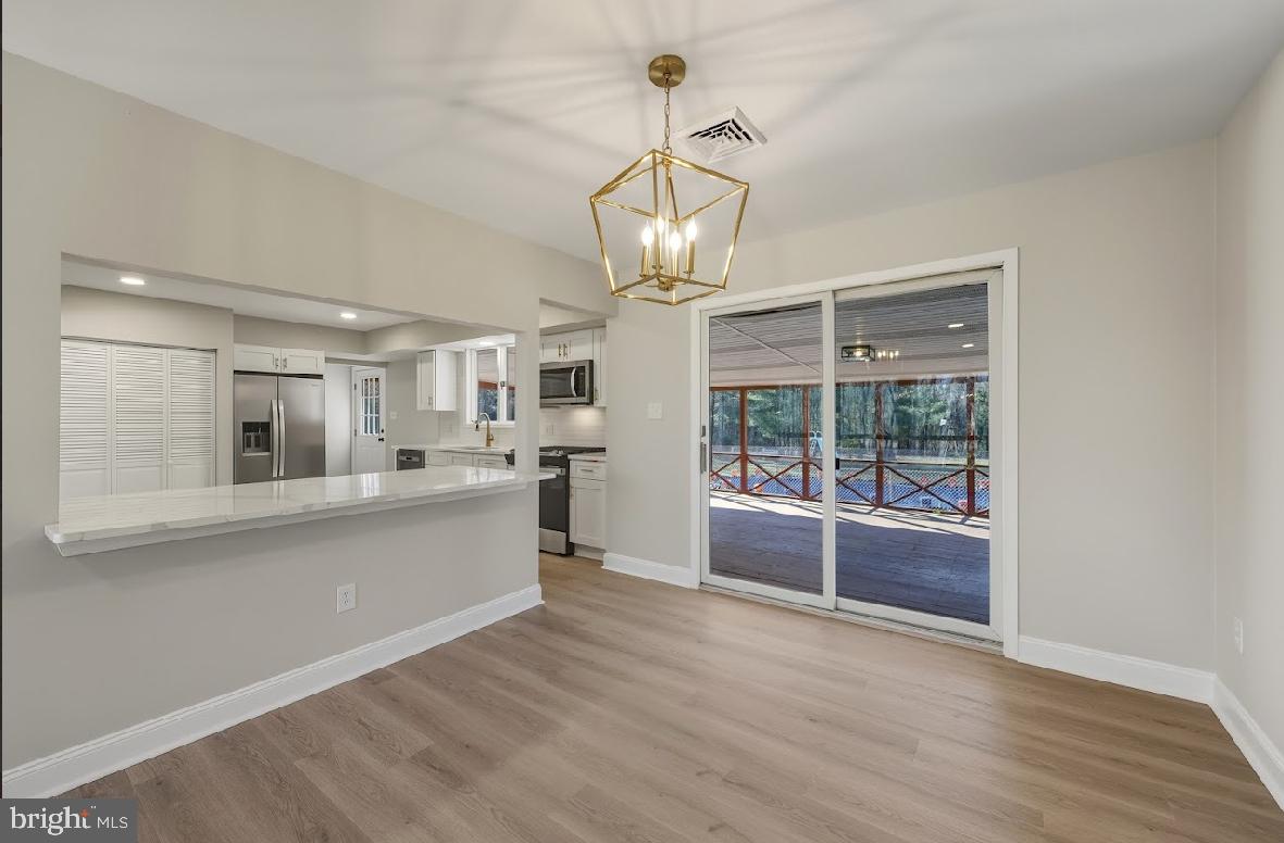 825 Mays Landing Road Hammonton, NJ 08037 - Photo 10 of 33 a view of a kitchen with granite countertop stainless steel appliances and a chandelier