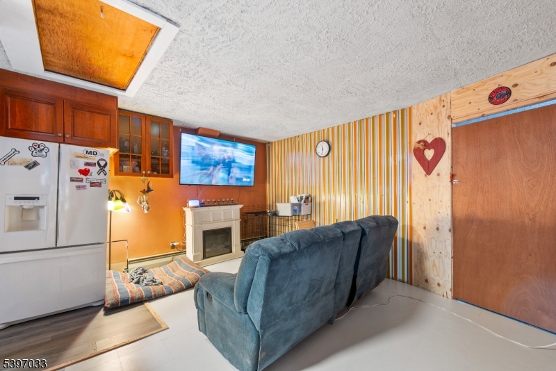 43 Meyers Road Montague, NJ 07827 - Photo 12 of 23 a living room with furniture a fireplace and a refrigerator