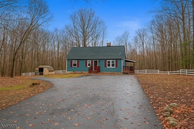 a front view of a house with yard and trees