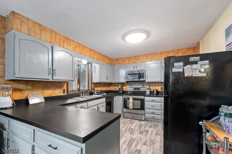 43 Meyers Road Montague, NJ 07827 - Photo 7 of 23 a kitchen with stainless steel appliances granite countertop a sink a stove and a refrigerator