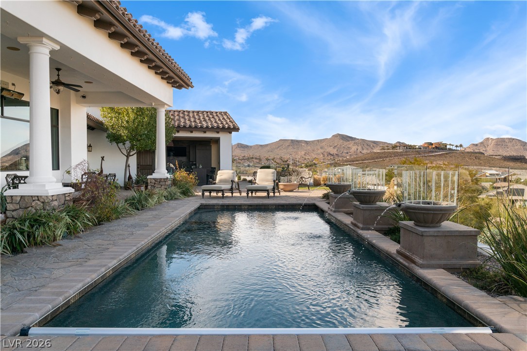1123 Christian Road Henderson, NV 89002 - Photo 49 of 94 An inviting backyard oasis offers a sparkling pool and breathtaking mountain vistas.