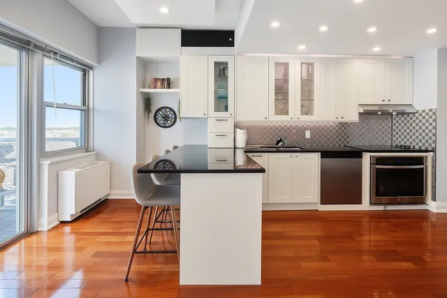a open kitchen with stainless steel appliances granite countertop a stove and a refrigerator