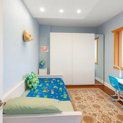 a room with painting on the wall and a rug