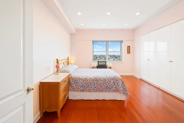 a bed room with a bed and a refrigerator