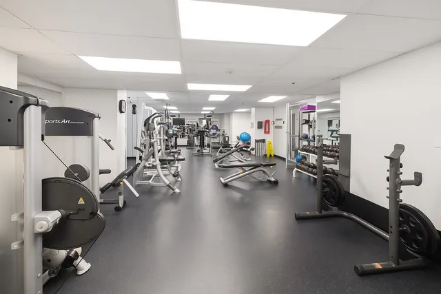 a gym room with lots of gym equipment