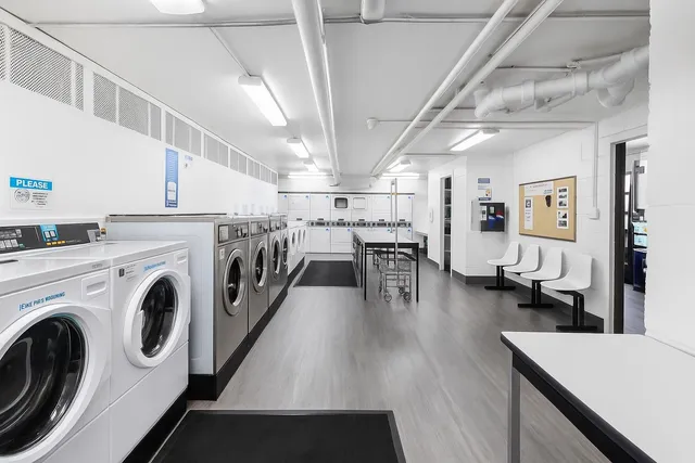 a view of a kitchen with furniture and wooden floor