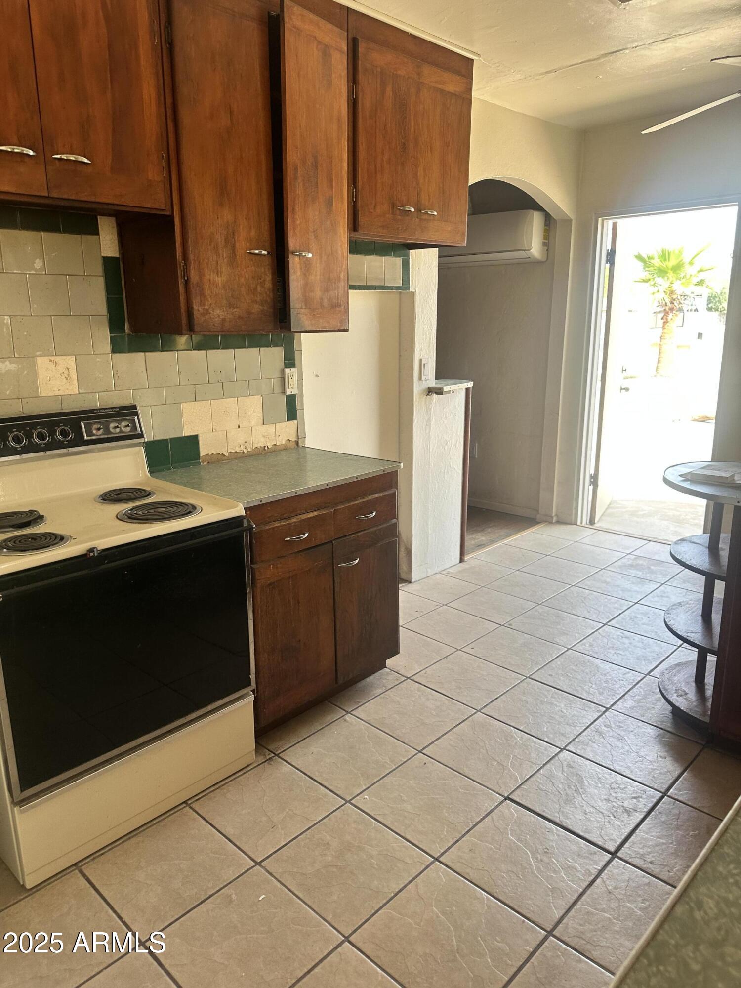 2621 North 14th Street Phoenix, AZ 85006 - Photo 11 of 24 a kitchen with stainless steel appliances a cabinets and a stove top oven
