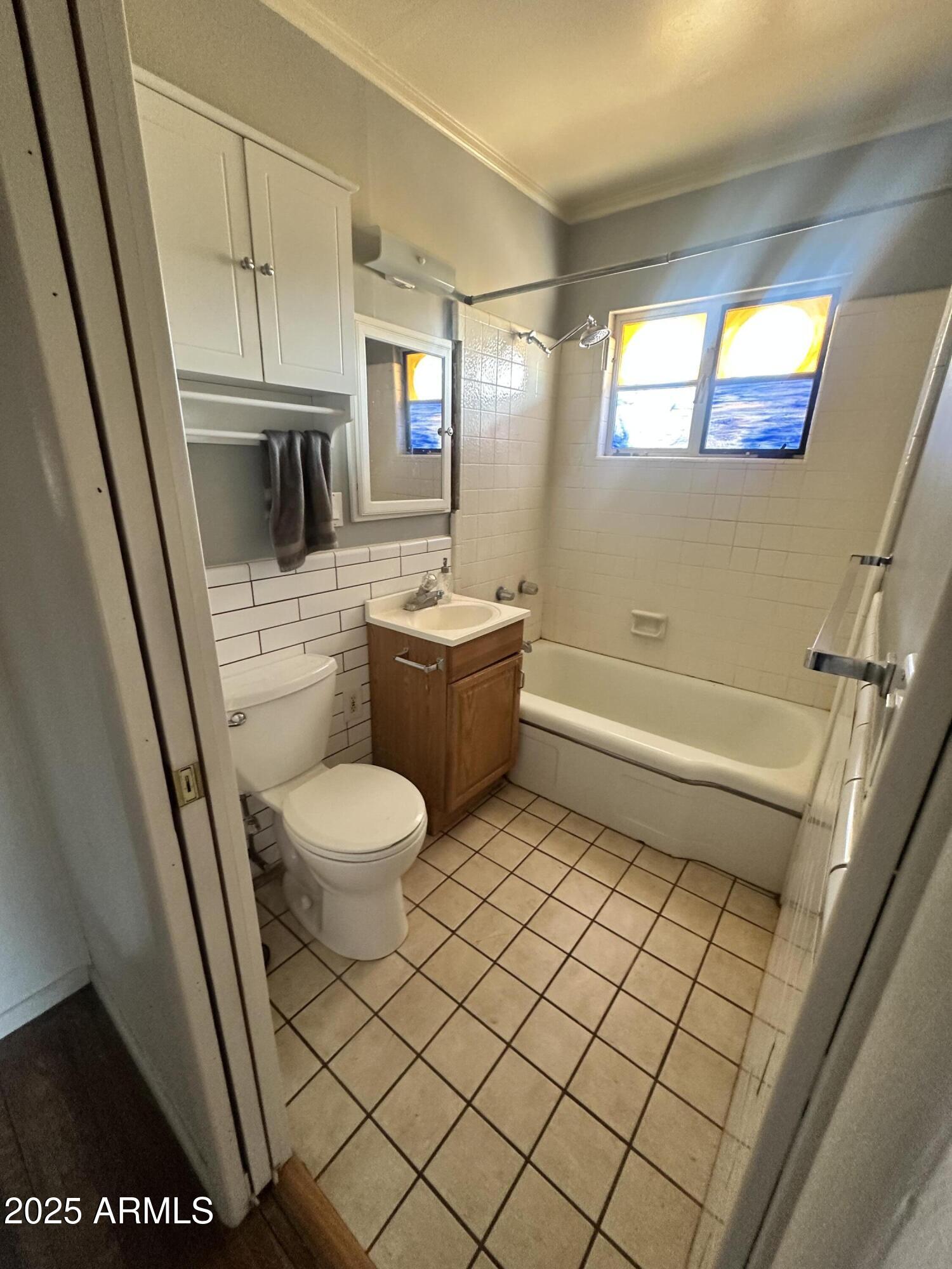2621 North 14th Street Phoenix, AZ 85006 - Photo 13 of 24 a bathroom with a sink a toilet and a shower