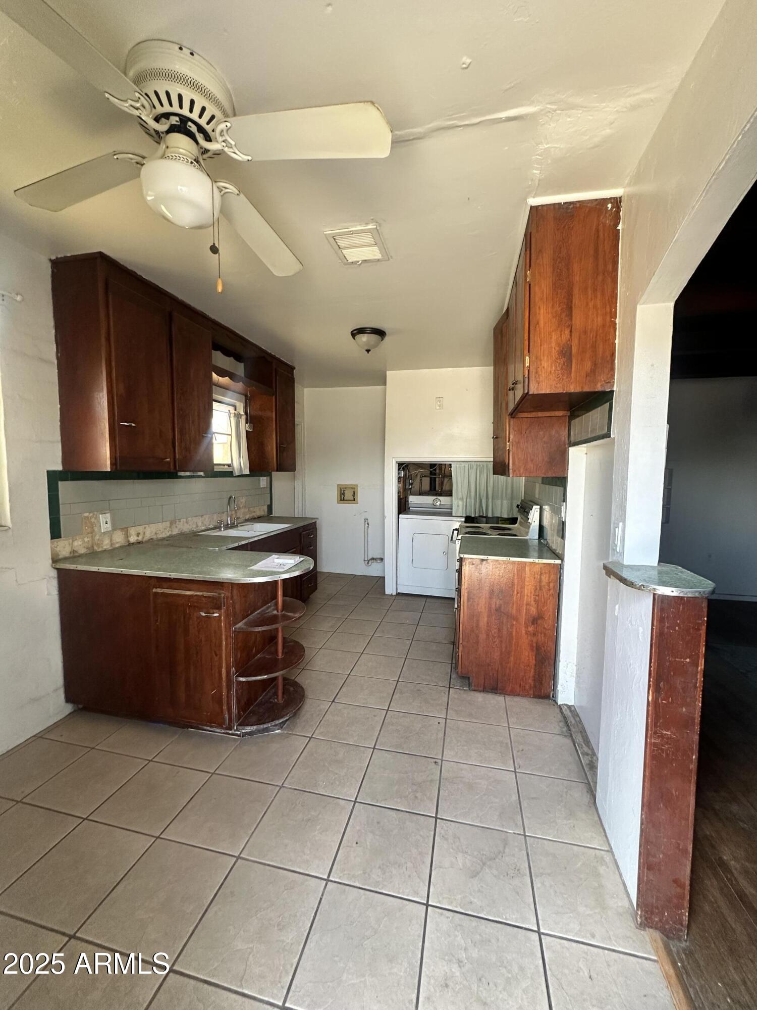 2621 North 14th Street Phoenix, AZ 85006 - Photo 3 of 24 a kitchen with stainless steel appliances granite countertop a stove top oven a sink a counter top space and cabinets