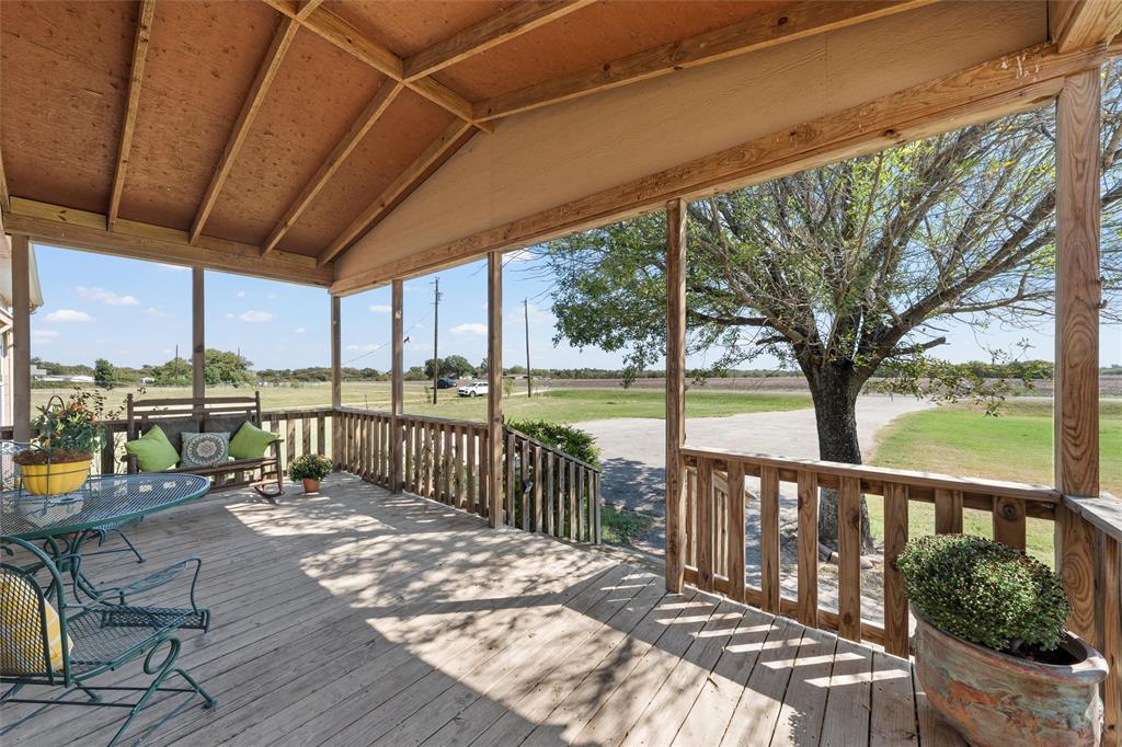 3449 Bluhm Road West, TX 76691 - Photo 30 of 40 a view of a patio with a table chairs and wooden floor