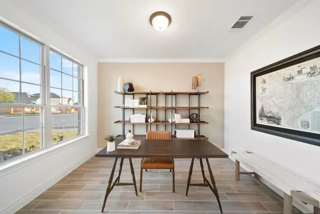 a view of a workspace with furniture and a window