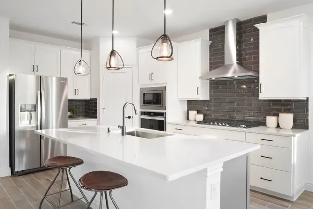 a kitchen with cabinets and stainless steel appliances