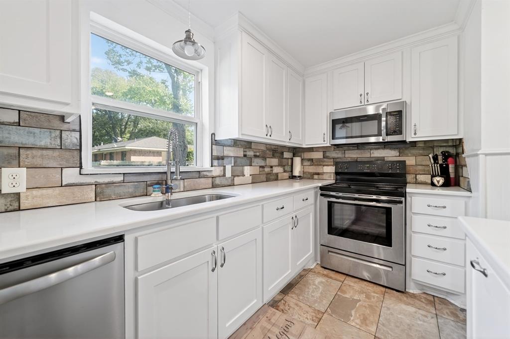 505 Laurel Road Athens, TX 75751 - Photo 12 of 32 Kitchen featuring white cabinetry, white countertops, stainless steel appliances, a multi-tone brick-patterned backsplash, and tile flooring