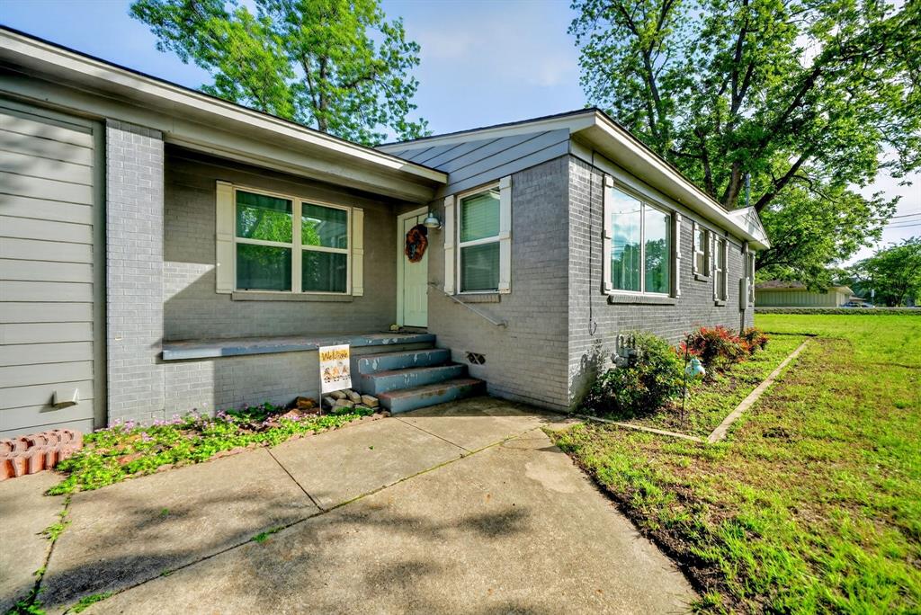 505 Laurel Road Athens, TX 75751 - Photo 5 of 32 Exterior featuring gray painted brick and siding, multiple windows, a concrete walkway, and a landscaped garden bed