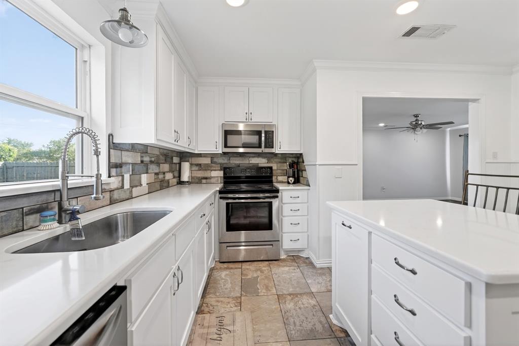 505 Laurel Road Athens, TX 75751 - Photo 10 of 32 Kitchen featuring white cabinetry, light-toned countertops, a stainless steel sink with a gooseneck faucet, a tile backsplash, and stainless steel appliances