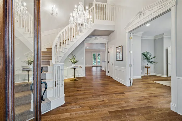 a view of entryway with wooden floor and stairs