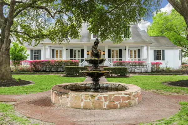 a front view of house with yard and green space