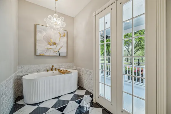 a hallway with white cabinets and wooden floor