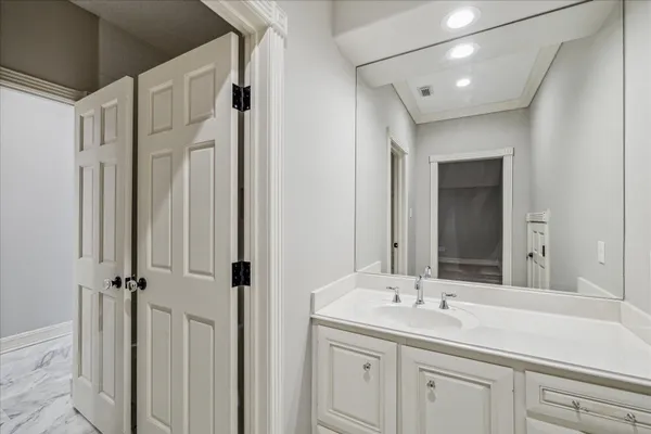 a kitchen with stainless steel appliances granite countertop a sink and dishwasher with white cabinets