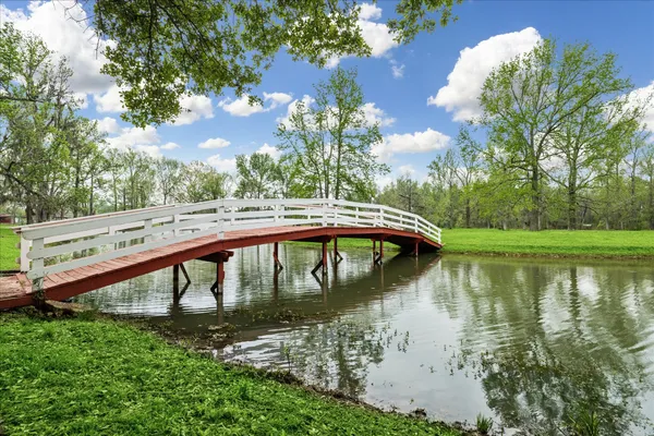 a view of a lake with a yard from a balcony