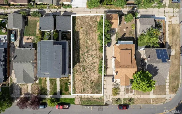 an aerial view of residential houses with outdoor space and street view