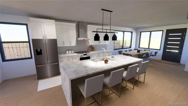 a kitchen with stainless steel appliances granite countertop a refrigerator a stove a sink a dining table and chairs