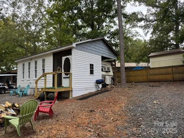 a view of backyard with outdoor seating and trees