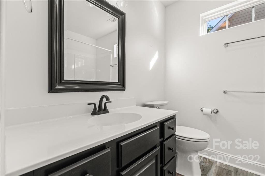 38 Grove End Road, Unit LOT/2 Fletcher, NC 28732 - Photo 24 of 39 a bathroom with a toilet a sink and mirror