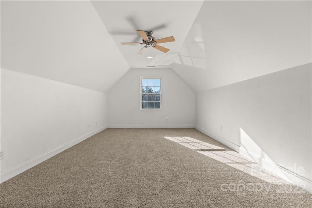 38 Grove End Road, Unit LOT/2 Fletcher, NC 28732 - Photo 28 of 39 an empty room with a ceiling fan and a window