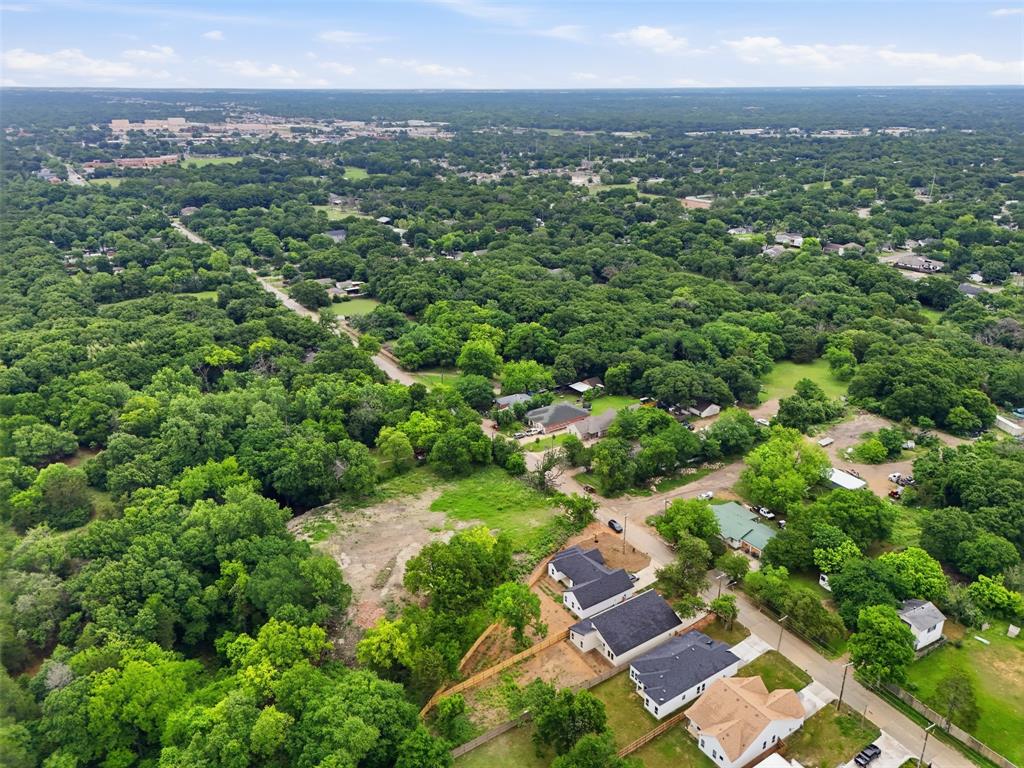 1111 Riverwood Road Dallas, TX 75217 - Photo 40 of 40 Aerial perspective showcasing a residential area amidst abundant mature trees