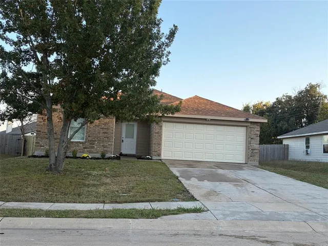 a front view of house with yard and trees