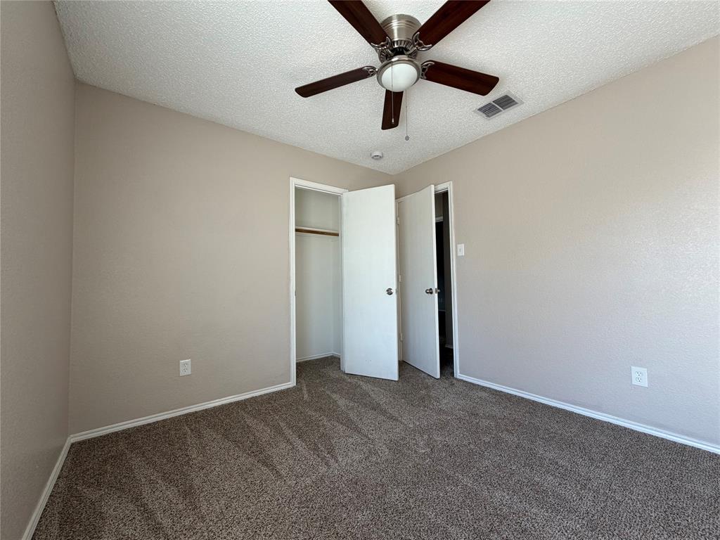 1826 Trailview Drive Terrell, TX 75160 - Photo 18 of 27 en empty room with ceiling fan and window